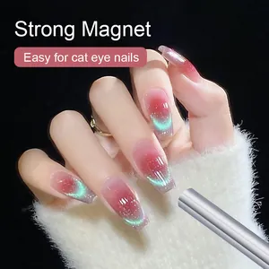 Strong magnetic tool for cat eye nails creating a green shimmer on pink coffin nails