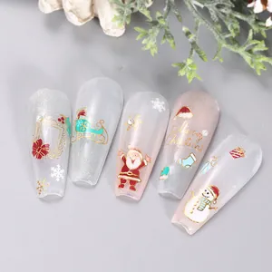 Detail of Christmas nail art featuring gold Santa, reindeer, and snowflakes motifs