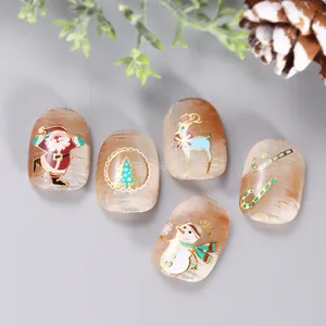 Detailed view of Christmas press-on nails with golden Santa and reindeer on cat-eye base