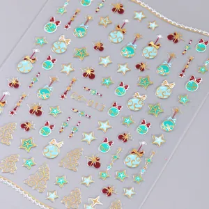 Macro detail of Christmas nail stickers with gold snowflake and reindeer patterns