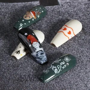 Christmas nail art stickers featuring reindeer, gnomes, and snowflakes on a dark background