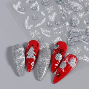 Macro detail of glitter Christmas nail stickers with snowflake and Jingle Bell patterns