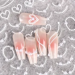 Detail of 5D white pearl heart embossed nail stickers on pink ombre gradient press-on nails