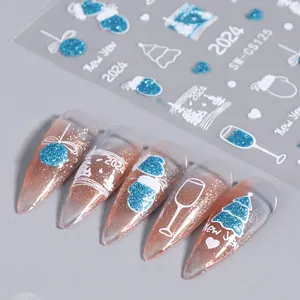 Detail of Christmas nail stickers with blue glitter snowflakes and New Year motifs