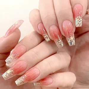Detail of pink gradient coffin nails with gold glitter and irregular sequins decoration
