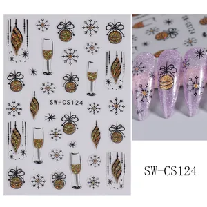 Detail of Christmas nail stickers with gold glitter snowflakes and champagne cup patterns