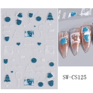Detail of 2024 New Year nail stickers with blue glitter and white snowflake patterns