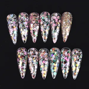 Pink heart and star glitter press-on nails with transparent base and almond shape spikes
