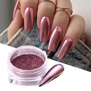 Rose gold chrome nail powder set with metallic mirror finish on denim background