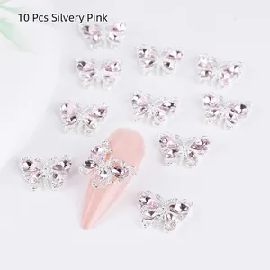 Detailed view of 10-piece silvery pink butterfly nail art charms with crystal rhinestones