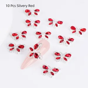 Detail of 10-piece silvery red butterfly nail charms with crystal rhinestones on tips