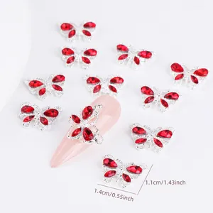 Silver alloy butterfly nail art charms with red rhinestones in a 1.4cm x 1.1cm size
