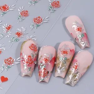 Detail of red rose 3D nail stickers with silver edges on pink ombre press-on nails