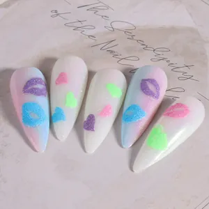Macro detail of 3D heart and lip patterns on glitter gradient almond fake nails