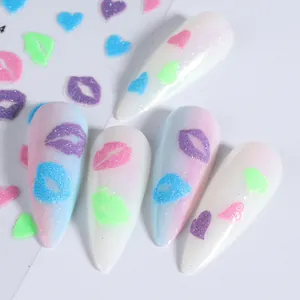 Macro view of 3D fluorescent nail stickers with glitter hearts and lips patterns