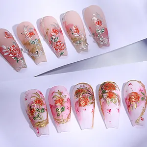 Detail of long trapezoid press-on nails with rose motifs and gold silver metallic accents
