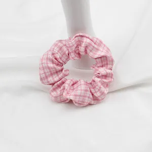Dettaglio dell'elastico per capelli a quadretti rosa e bianchi con tessuto arricciato
