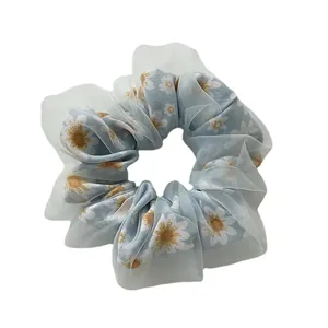 Light blue double-layer organza scrunchie with white daisy floral pattern for buns
