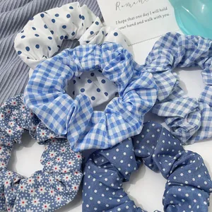 Close-up of blue ocean-style hair scrunchies with polka dots and checkered patterns