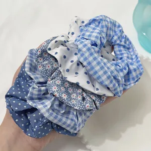 Detail of blue patterned scrunchies showing polka dots and plaid fabric textures