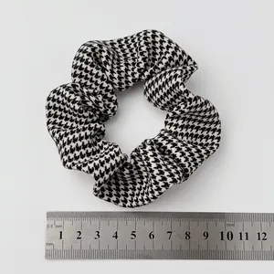 Detail of black and white houndstooth scrunchie with ruler showing 10cm diameter size