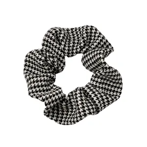 Chic black and white houndstooth oversized scrunchie hair tie with tweed fabric texture