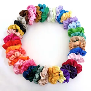 Wholesale set of colorful satin silk scrunchies in vibrant shades on white background