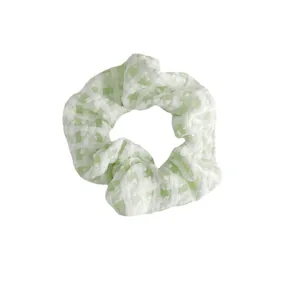 Light green and white plaid scrunchie with a soft fabric texture for a sweet summer style