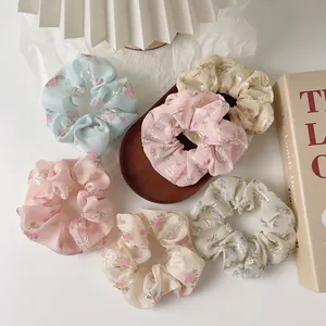 Set of six floral organza hair scrunchies with delicate gold embroidery and pastel colors