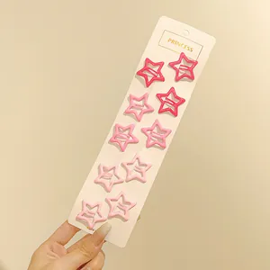 Set de 10 pinzas para el pelo con forma de estrella rosa en tarjeta de cartón