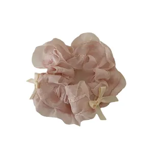 Pink organza scrunchie with beige bows and lace edges, stylish hair tie for ponytails