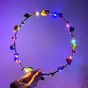 Detail of LED glowing floral headband showing multi-color lights and flower textures