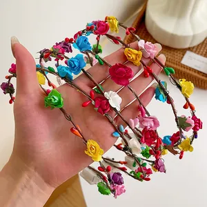 Colorful LED flower headband with faux roses and berries on a woven vine base