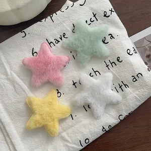 Barrettes à cheveux en peluche étoile en couleurs pastel sur un fond de tissu doux