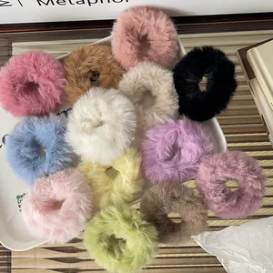 Flat lay of soft plush scrunchies in eleven candy colors displayed on a white tray