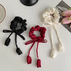Three-piece set of satin silk scrunchies with long ribbons and tulip flower charms