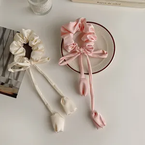 Elegant satin tulip bow scrunchies in pink and cream with long streaming ribbons