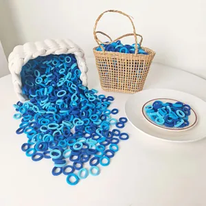 Close-up of bulk elastic blue hair ties in a decorative basket for gentle hair styling