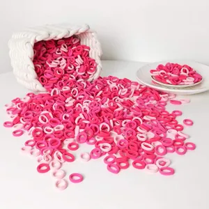 Close-up of bulk pink seamless high-elastic hair ties spilling from a woven basket