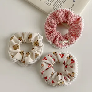 3-piece plush hair scrunchies set with cartoon bear patterns, lace edges and bows