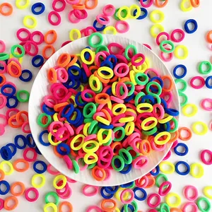 Macro shot of 2cm candy-colored high elasticity seamless hair bands in a white ceramic bowl