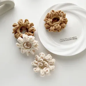 Detail of plush chenille hair ties in coffee and cream colors with soft fluffy texture