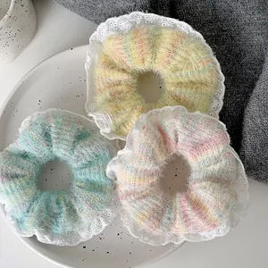 Detailed knit hair scrunchies with white lace trim and pearls in pastel colors