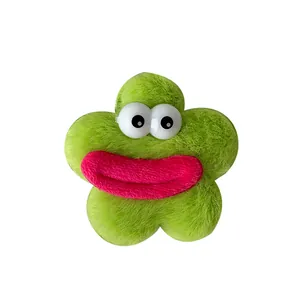 Barrette fleur en peluche verte avec de gros yeux rigolos et des lèvres de dessin animé
