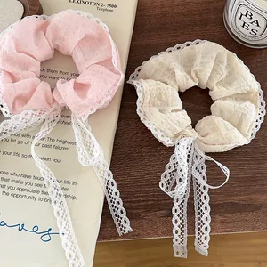 Lace scrunchies with long ribbons in pink and beige colors for elegant hair styling