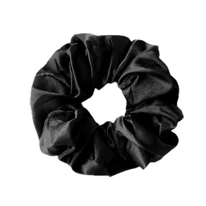 Lustrous black satin scrunchie with elegant folds for hair, minimalist silk hair tie set