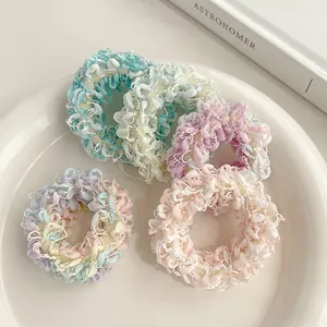 Lot de quatre chouchous en peluche aux couleurs pastel bleu vert violet et rose