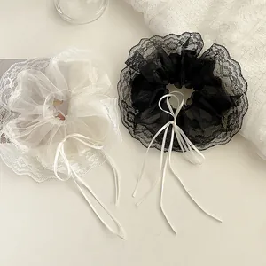 Lace bow hair scrunchies in black and white mesh ribbon with an elegant ruffled design