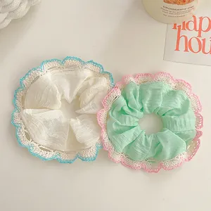 Lace-trimmed fabric scrunchies in cream and mint green for sweet summer hairstyles