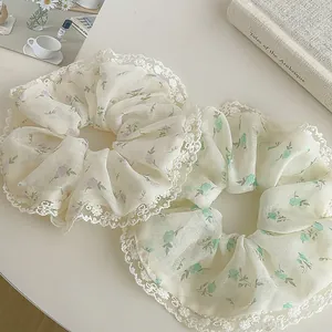 Floral print scrunchies with white lace edges in soft lavender and green pastoral styles